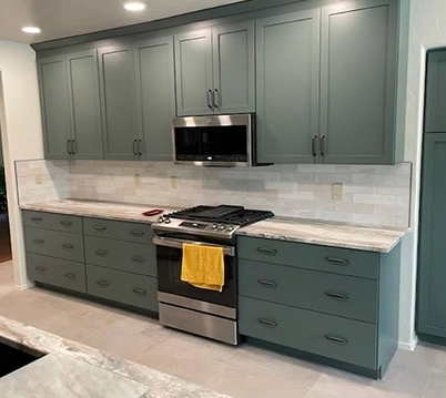 Modern Kitchen with Green Cabinets and Stainless Steel Appliances